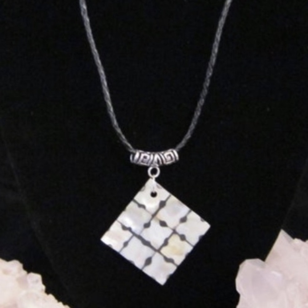 Handmade mother of pearl checkerboard piece on black braided adjustable cord